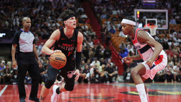 Miami Heat guard Tyler Herro (14) dribbles the basketball as Washington Wizards guard Bilal Coulibaly (0) defends during the fourth quarter at Kaseya Center. Mandatory Credit: Sam Navarro-USA TODAY Sports